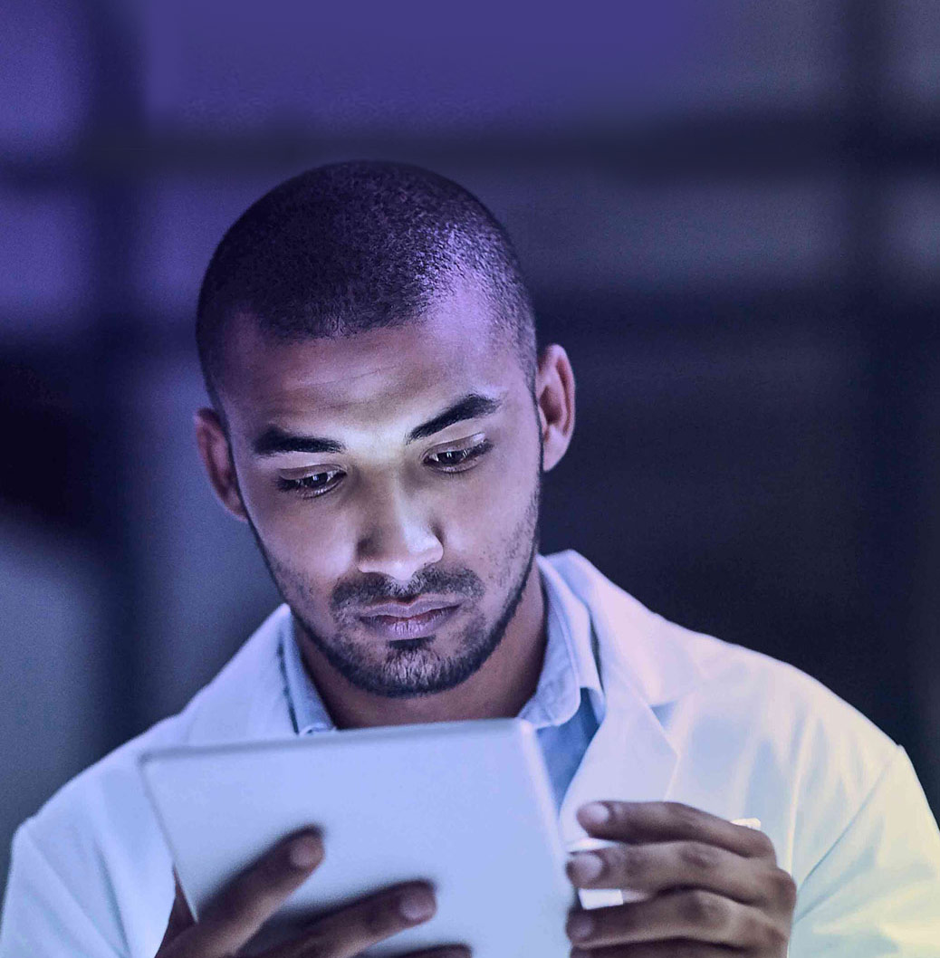 a man looking at a tablet for medical information
