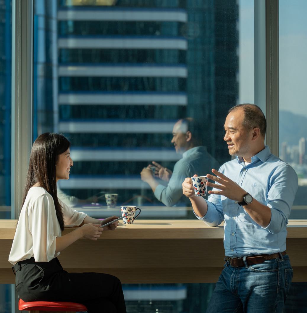 a man and a woman sitting at a table in front of a window